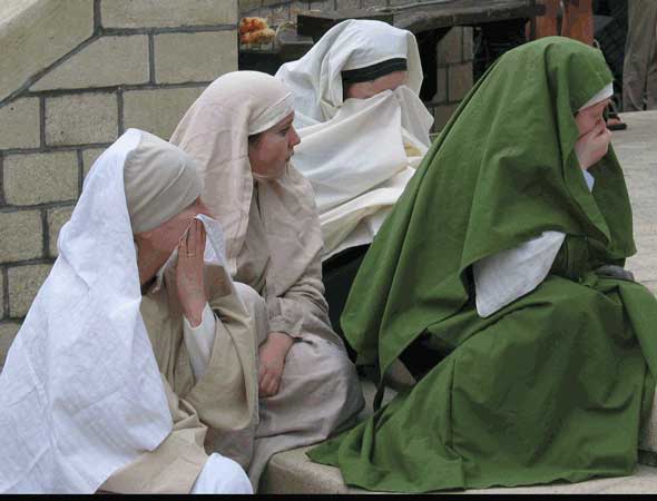 crowds gather at the foot of the cross
